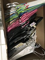 Box of assorted vinyl-coated and foam-covered wire hangers