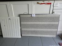 Wide view of both boards leaning against cabinetry