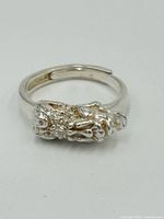 Front view of the silver ring showing dragon design and adjustable band.