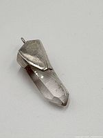 Close-up front view showing the quartz crystal with sterling silver mount and bail.