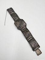 Full view of the bracelet with visible embossed panels and safety chain.