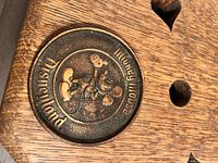 Front side of bronze-like small souvenir plate with embossed Mickey Mouse and Disneyland text.