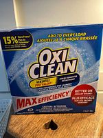 Closed blue and white OxiClean Max Efficiency box showing labeling and 11 lb weight