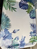 Top view showing full tropical leaf and flower design on the tray surface