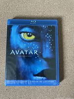 Front cover of Avatar Blu-Ray case showing blue Na'vi face and title.