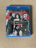 Front cover of the Blu-Ray case featuring Batman, Wonder Woman, and Superman with the title 'Batman v Superman: Dawn of Justice Ultimate Edition'.