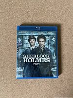 Front view of the Sherlock Holmes Blu-Ray case showing main actors and movie title.
