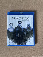Front cover of The Matrix Blu-Ray case showing Neo, Trinity, and Morpheus.
