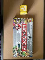 Monopoly board game box featuring Nintendo characters such as Mario, Luigi, and Yoshi