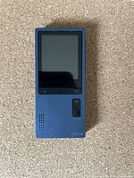 Front view of blue Borne MP3 player showing screen, control buttons, and speaker