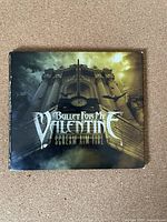 Front cover of the CD album "Scream Aim Fire" by Bullet For My Valentine showing detailed artwork with band name and album title.