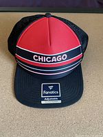 Front view of Chicago Blackhawks Fanatics hat with 'CHICAGO' text and original sticker on brim
