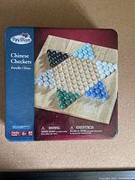 Photo of Pavilion Chinese Checkers game box showing wooden star-shaped board and colored marbles set.