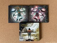 Front covers of Aftermath: Ascension, Aftermath: Descension, and No World for Tomorrow CD albums shown on carpeted surface.
