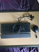 Corsair wired keyboard with wrist rest, wired mouse and 1080P webcam with USB cable.