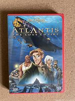 Front cover of DVD case showing animated characters and ship from Atlantis The Lost Empire