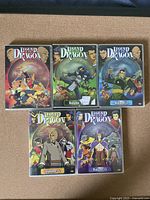 Front cover artwork of the 5 DVD volumes showing animated characters and series title.