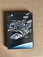 Front cover of Starship Troopers DVD showing spaceship and title.