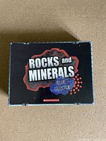 Top view of the closed black box labeled 'Rocks and Minerals Deluxe Collection' from Scholastic.