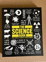 Front cover of 'The Science Book' showing title, subtitle, and various science-related graphics and phrases.