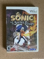 Front cover of Sonic and the Secret Rings game for Nintendo Wii showing Sonic character and game title.