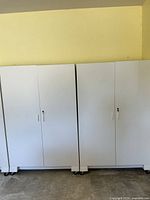 Front view of both white rolling cabinets side by side