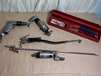 Group shot of drills, blow guns, hose, wand and tray