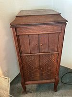 Closed oak Victrola cabinet front and sides