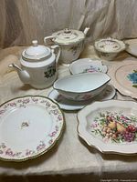Group shot showing teapots, sugar bowl, gravy boat, various plates