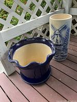 Overall view of cobalt blue planter and cream umbrella stand