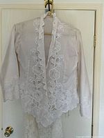Embroidered sheer blouse on hanger