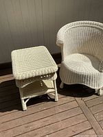 Wicker side table beside barrel chair