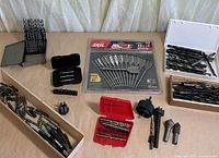 All items laid out on table including sealed Skil set and various loose bits