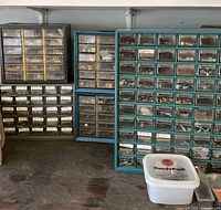 Multiple drawer organizers and plastic tub on workbench