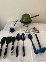 overall lot showing fondue pot set, sauce pot, utensils laid out