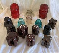 Group shot of all glass and ceramic insulators showing colors and shapes