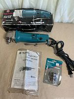 Overview showing drill, box, manual and sealed accessory