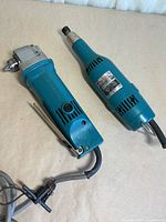 Both Makita power tools side by side showing overall condition