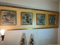 Long wood panel with four framed square jester tiles and two diamond plaques underneath