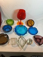 Group shot of all glass ashtrays, lighter and goblet