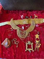Overview showing belt, collar, keys, hairpins, ornaments, glass animals, leather pouch