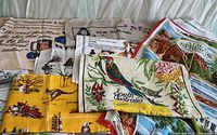 Overview of stacked tea towels showing various Australian and New Zealand designs