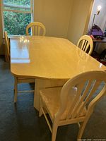 Full view of dining table with chairs around it
