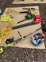 Overview of all yard tools and cords on cardboard