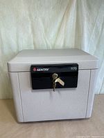Front view of Sentry 1170 safe with keys in lock