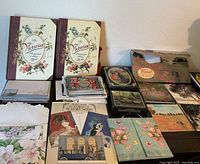 Overview of lot including Victorian Scrapbook books, postcard stacks and stationery
