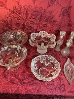 group shot of all cut glass pieces on red cloth