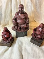 Front view of all three Buddha figurines showing size gradation