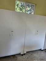 Front view showing both white rolling cabinets side by side