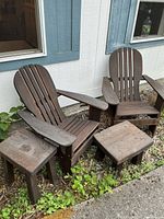 Full view of two Adirondack chairs, side table, and footstool